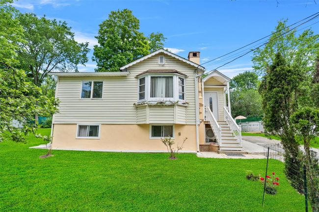 Rear view of property with a chimney and stucco siding | Image 4