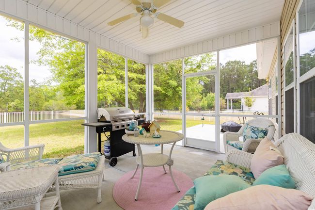 Sunroom / solarium featuring ceiling fan | Image 24