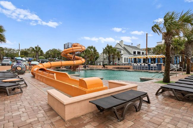 Community pool featuring a patio area and a water slide | Image 33
