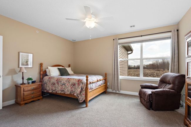 Gorgeous Primary/Owner's suite has heating floors, granite countertops, custom double vanity, walk-in closet with pocket door and walk-in shower with tile surround! | Image 13