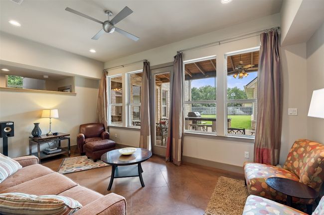 Tiled living area with a ceiling fan, baseboards, and recessed lighting | Image 13