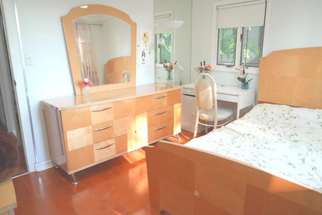 Bedroom featuring wood finished floors and arched walkways | Image 9