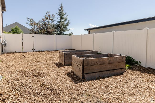 Fenced backyard with a gate and a garden | Image 51