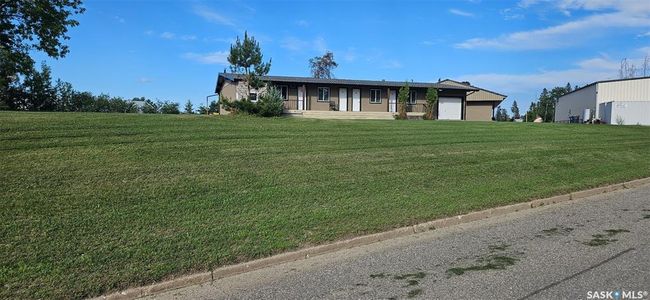 Ranch-style home featuring a front lawn, a garage, and covered porch | Image 10