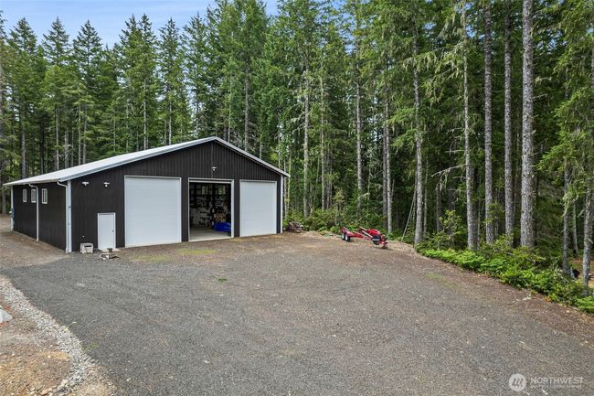 This is such a wonderful diversified property. It has so much to offer. The over the top garage/shop, the beautifuly landscaped property with underground drainage, professionally built retaining walls. The gorgeous boat dock with it's own boat lift. (There is a boat ramp at the end of the lake). All electrical is on the property. Fiber optics is on the property and in the garage. The future home site is ready to go. All you need is your own beautiful design. The septic is in and beautifully installed. The well is ready to go. All this property needs is you. | Image 20