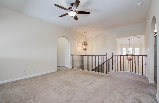 Beautiful wrought iron balusters and matching lanterns over foyer and top of stairs. | Image 25