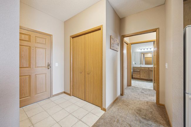 Welcome home! Inviting condo entry with stylish tile floor and spacious coat closet - a perfect start to comfortable, easy living. | Image 5