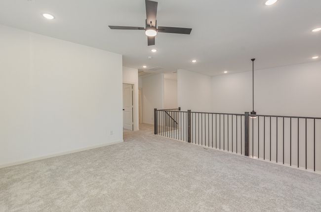 Unfurnished room featuring carpet floors, a ceiling fan, attic access, and recessed lighting | Image 17