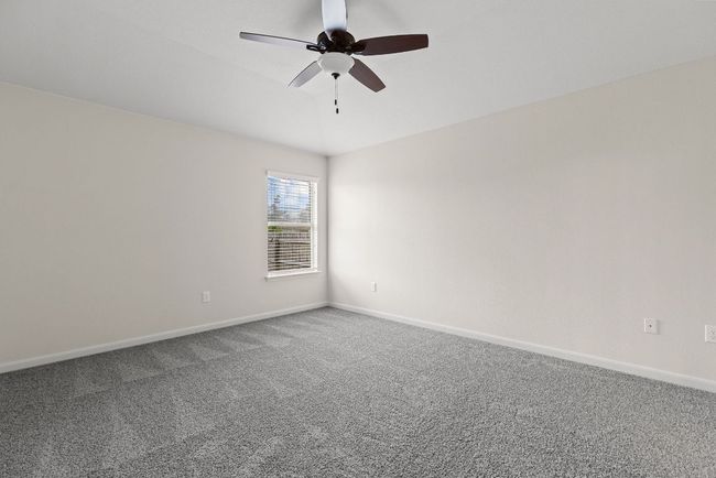 Spare room featuring carpet, ceiling fan, and baseboards | Image 8