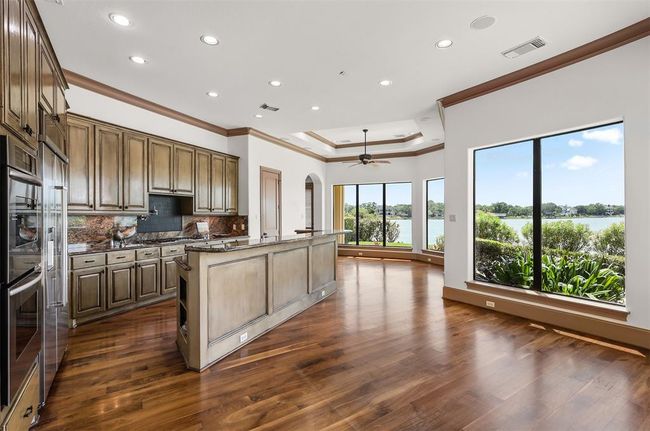 The dining space adjacent to the kitchen provides a casual atmosphere, complete with stunning views of the lakefront. | Image 19