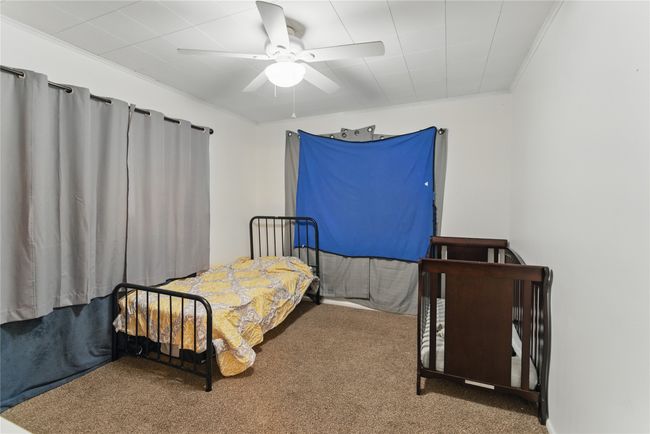 Bedroom featuring ceiling fan, ornamental molding, and carpet flooring | Image 19