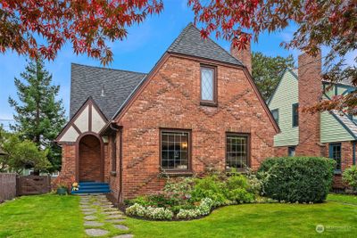 Stately 1929 Tudor exudes charm & functionality. | Image 1