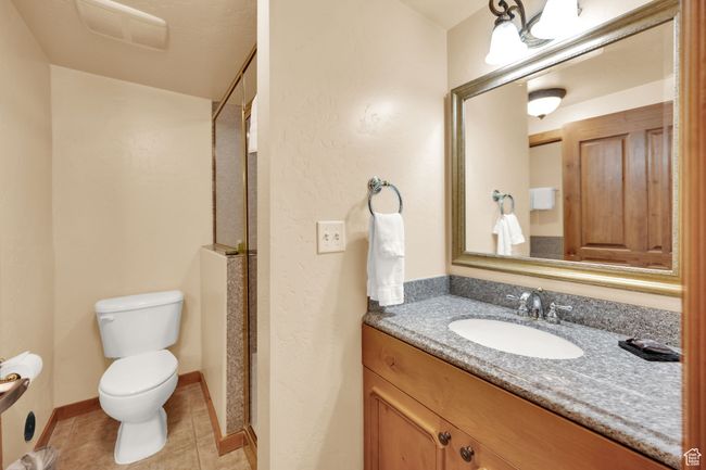 Bathroom with visible vents, baseboards, toilet, tile patterned floors, and vanity | Image 19