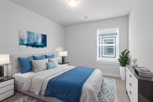 Secondary bedroom features plush carpet, neutral paint and a large window with privacy blinds. | Image 17