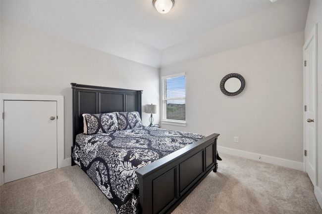 Bedroom with light carpet and baseboards | Image 33