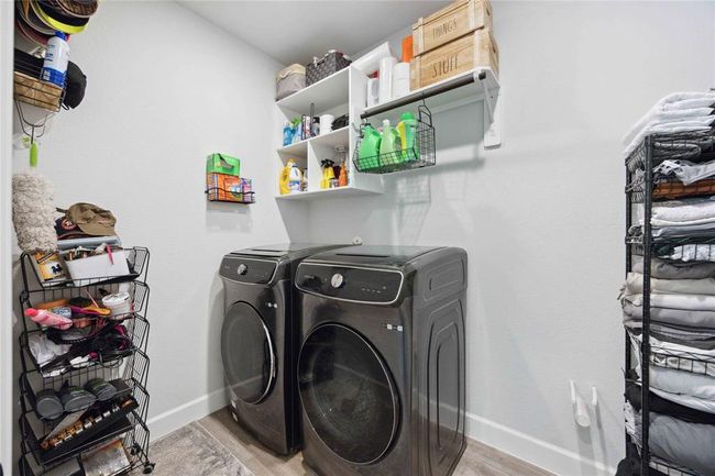 This laundry room features modern appliances, ample shelving, and organized storage options, providing a functional and efficient space for laundry tasks. | Image 20