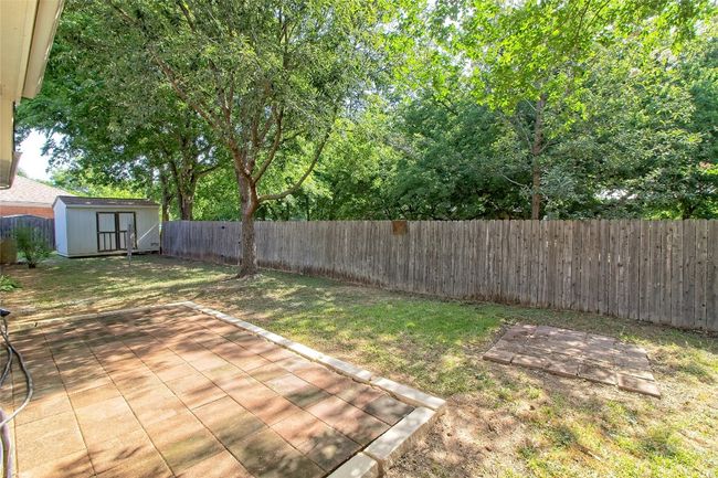 Fenced backyard featuring a shed and a patio | Image 30