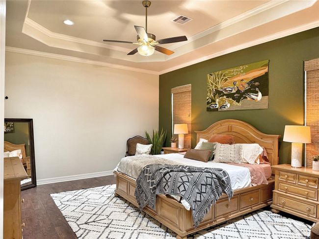 Large Primary bedroom boast coffer ceilings, crown molding and custom blinds | Image 11