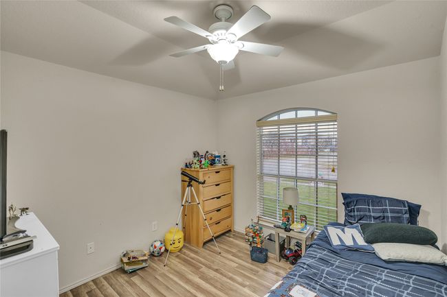 Bedroom with wood finished floors and a ceiling fan | Image 22