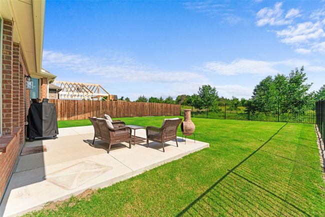 Fenced backyard with a patio | Image 30