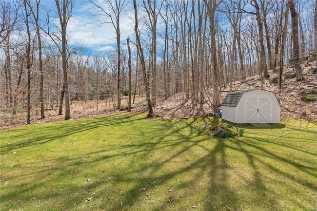 Early spring view of the rear yard and storage shed. Generator behind shed. | Image 25