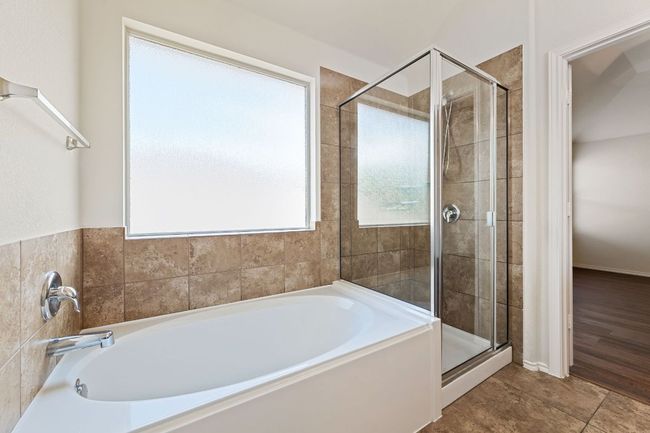 Full bath featuring a bath and a shower stall | Image 26