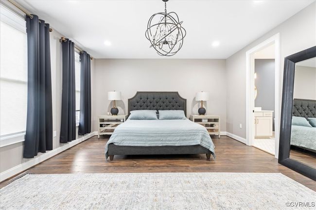 Bedroom with recessed lighting, wood finished floors, baseboards, and an inviting chandelier | Image 26