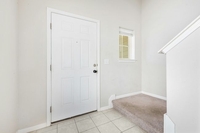 Entryway with light tile patterned floors and baseboards | Image 4