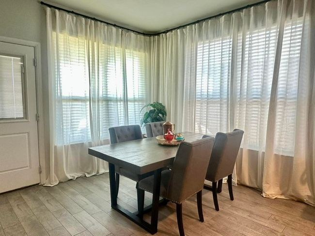 Dining area with light wood-type flooring | Image 12