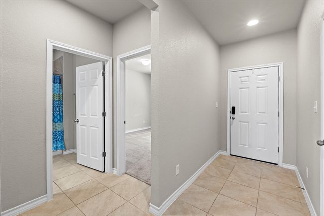 Entryway featuring baseboards and light tile patterned flooring | Image 13