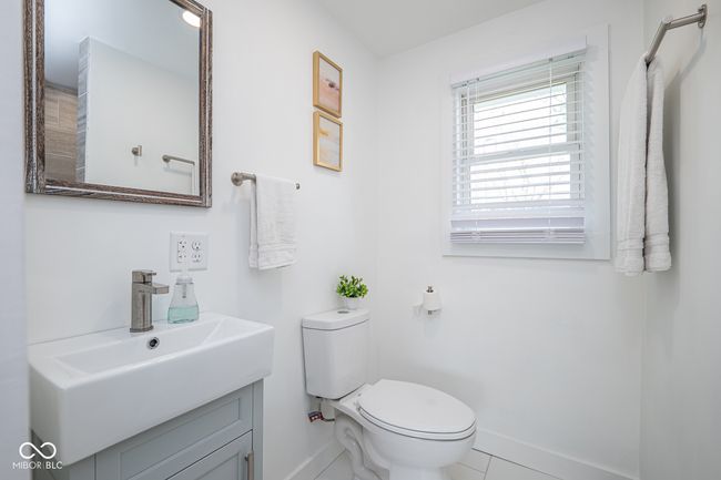 half bathroom featuring vanity, toilet, baseboards, and tile patterned floors | Image 22