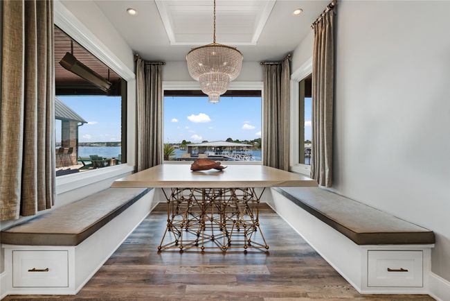 Kitchen with stainless steel appliances, light wood-style floors, tasteful backsplash, white cabinets, and plenty of natural light | Image 23