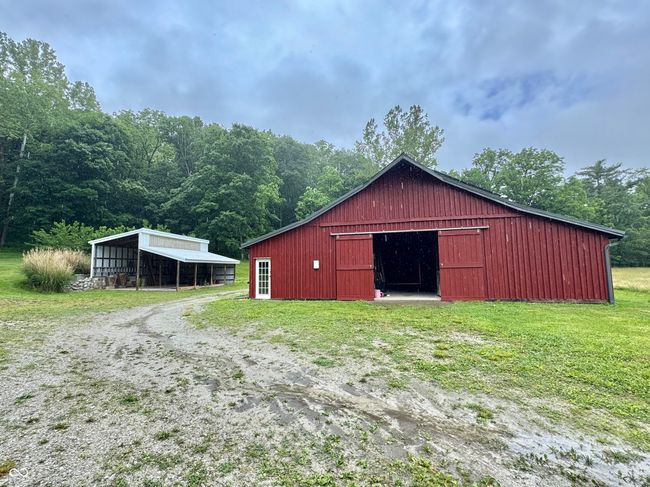 view of pole building with a carport and a lawn | Image 38