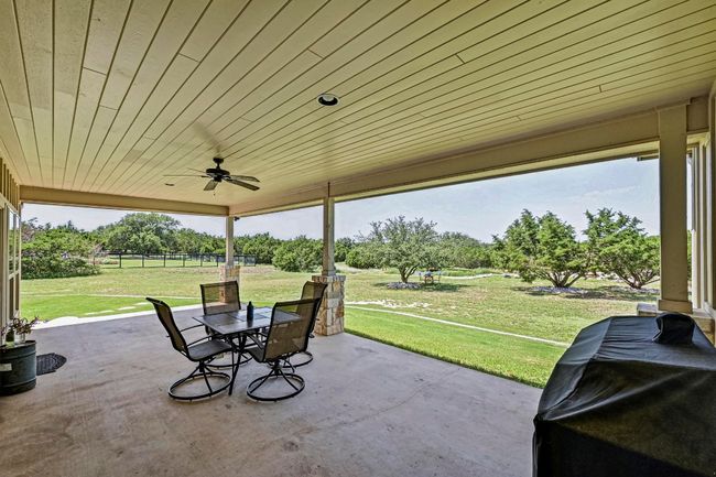 View of patio featuring outdoor dining space and ceiling fan | Image 30