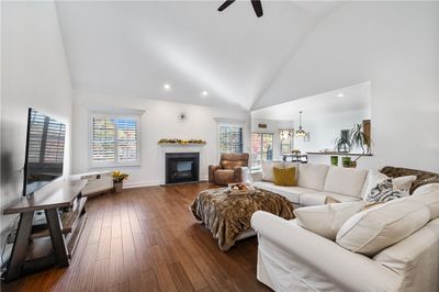 A gas fireplace and custom plantation shutters create the perfect ambiance. | Image 3