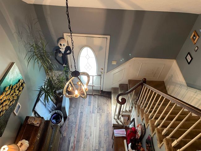 Entrance foyer featuring wood finished floors, wainscoting, stairway, and a decorative wall | Image 24
