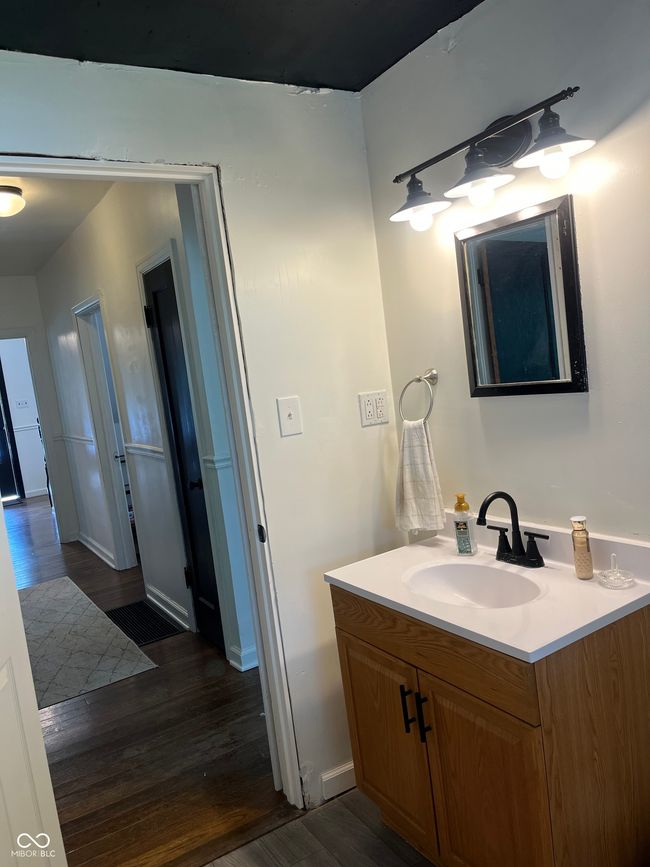 bathroom with wood finished floors, vanity, and baseboards | Image 10