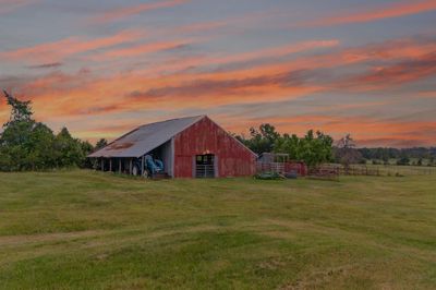 Nothing says Texas more than a tractor, red barn and a sunset. | Image 1