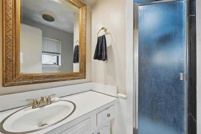 Bathroom featuring a stall shower and vanity | Image 23