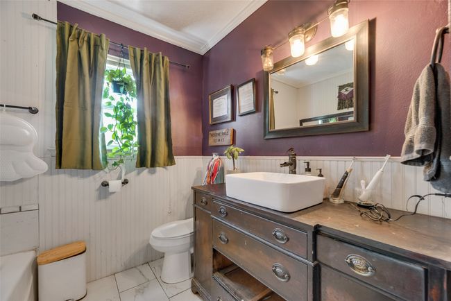 Bathroom featuring crown molding, vanity, toilet, marble finish floor, and a wainscoted wall | Image 21