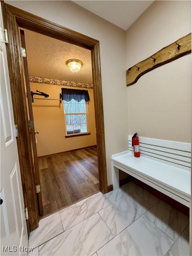 Mudroom with marble look tile flooring | Image 14