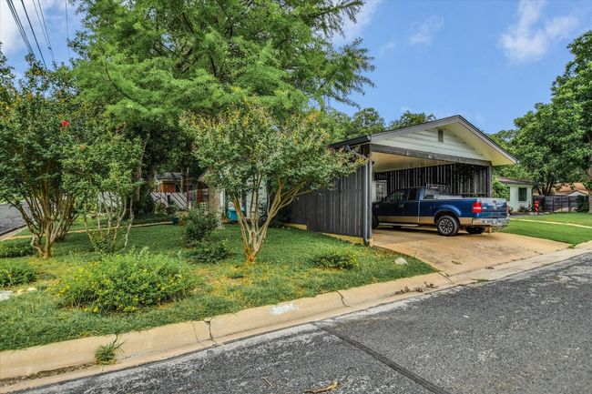 View of front of house with an attached carport, concrete driveway, and a front yard | Image 18