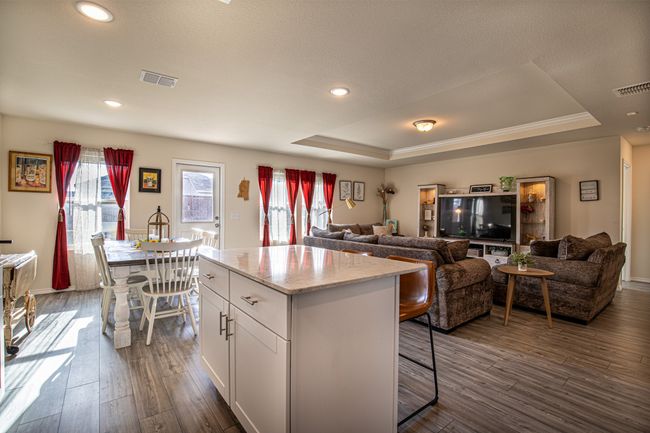Kitchen with a raised ceiling, white cabinets, dark wood-style floors, plenty of natural light, and recessed lighting | Image 5