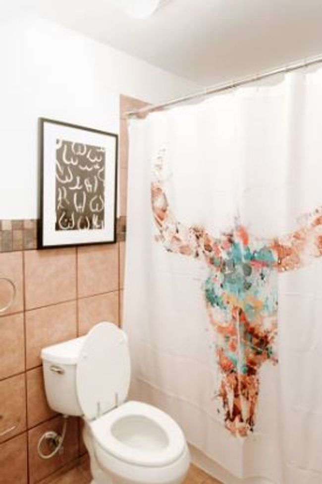 Bathroom featuring tile walls and a shower with curtain | Image 17