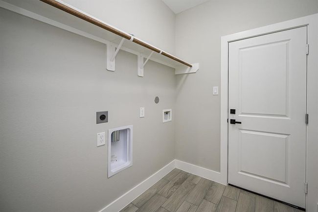 Utility Room Is Located Inside The Home, Next To The Garage, & Also Includes Shelving Above Respected Appliances | Image 18