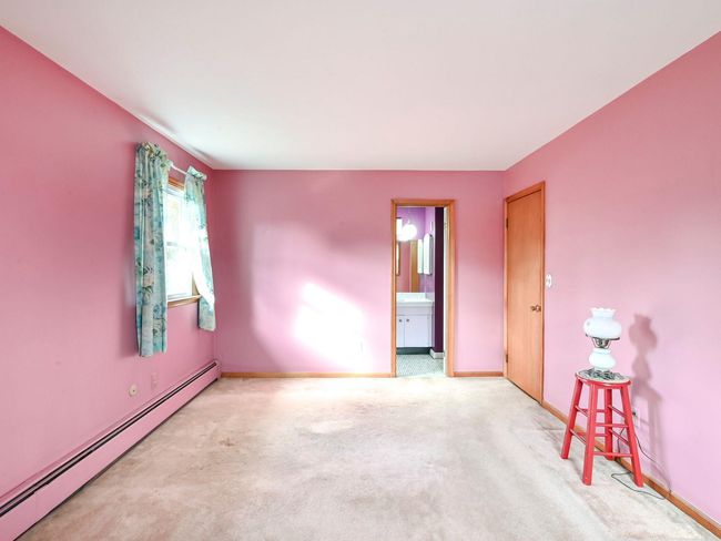Carpeted spare room with a baseboard heating unit | Image 14
