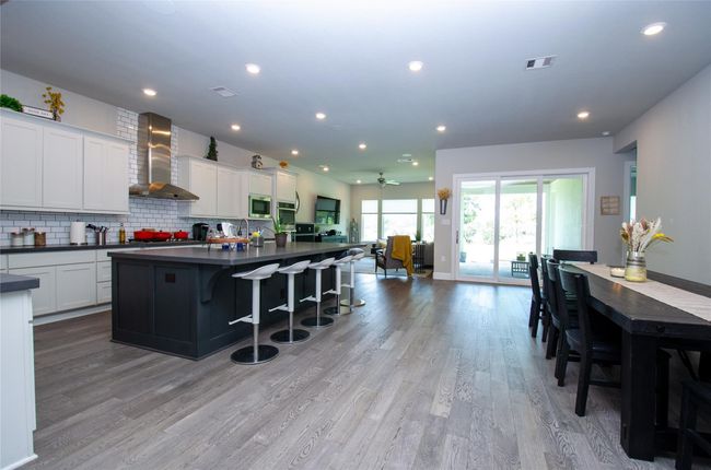 Bright and open main living areas with views out to the backyard. | Image 4