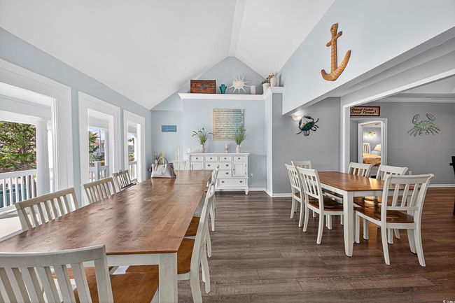 Dining area with dark wood-style flooring and high vaulted ceiling | Image 32