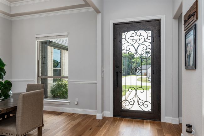 Entrance foyer with baseboards, ornamental molding, and wood finished floors | Image 5