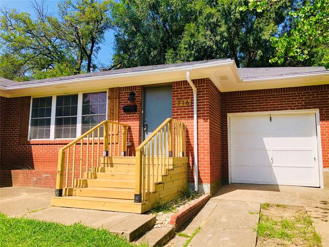 Single story home featuring driveway, a garage, and brick siding | Image 26